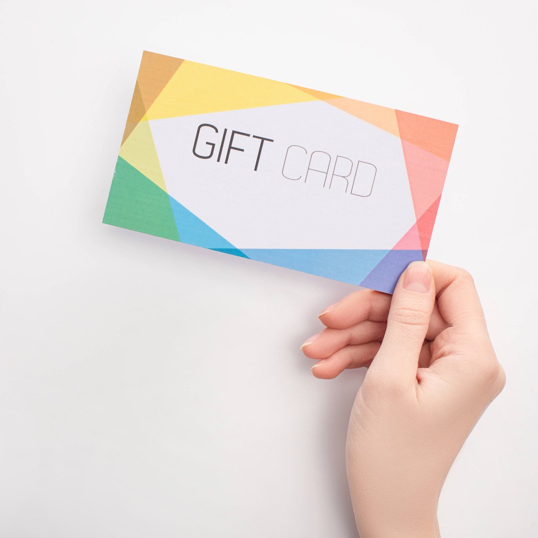 Hand holding a gift card on a white background